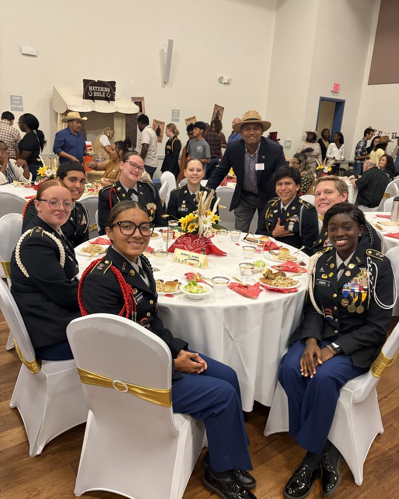 Victor Arias seated at a head table with JROTC cadets in dress uniform at the Annual Youth Coalition Awards banquet in Fort Myers